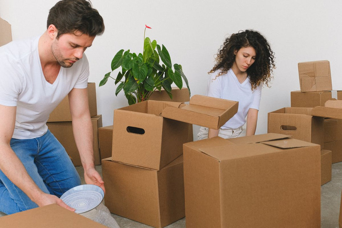 Couple planning a move surrounded by packing boxes