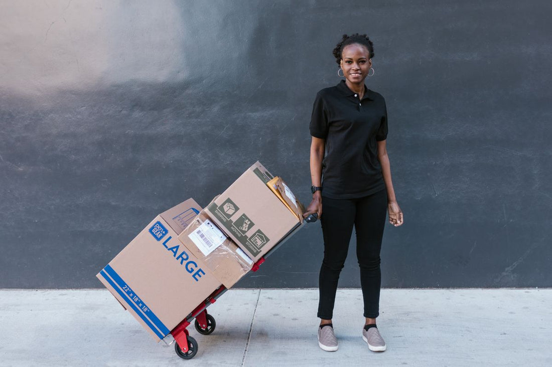 Mover hauling large boxes away on a dolly