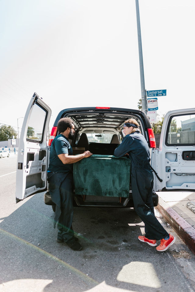 Movers loading furniture into a moving van