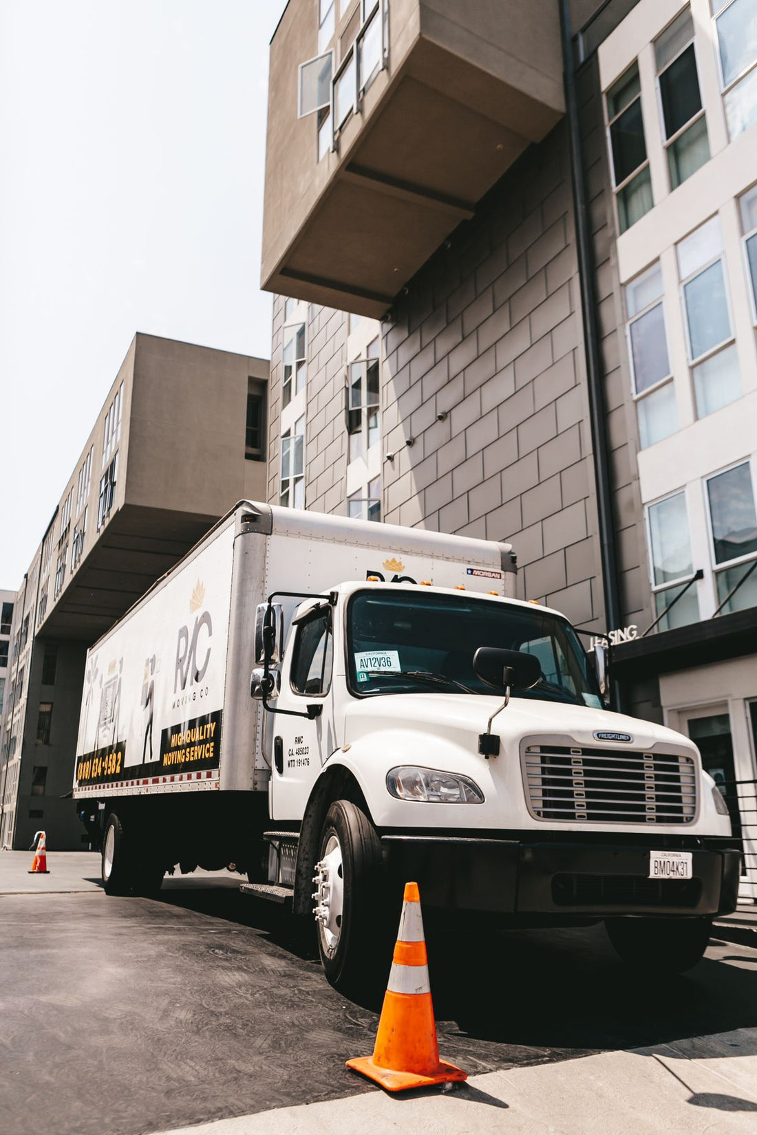 Moving company truck parked outside an apartment building