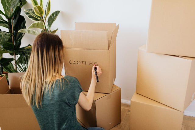 Labeling a box packed with clothes